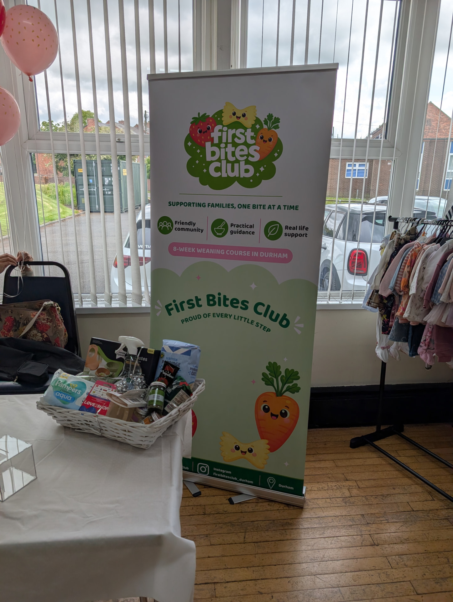 A local business roller banner and display table set up at one of our markets